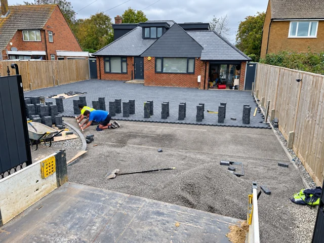 Team preparing the remaining entrance area beside laid block paving